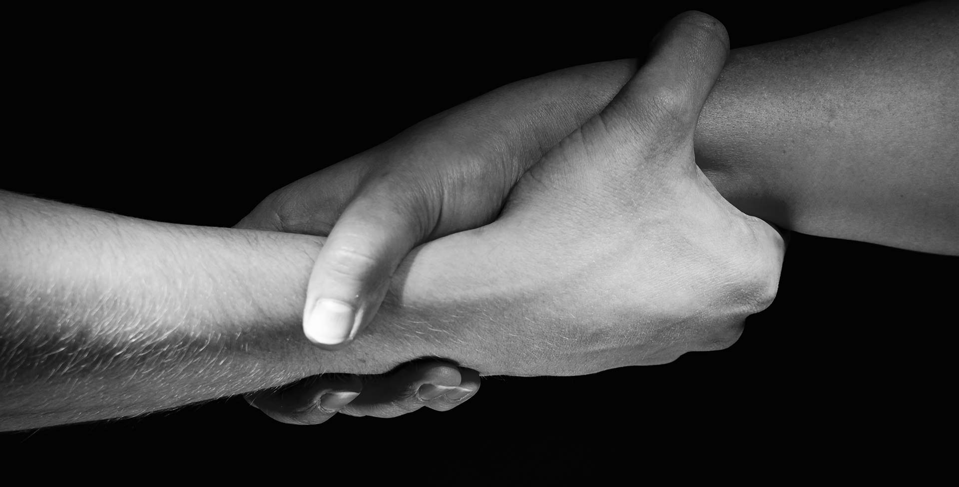 A close-up of hands providing support through Just Believe Foundation in Oceanside