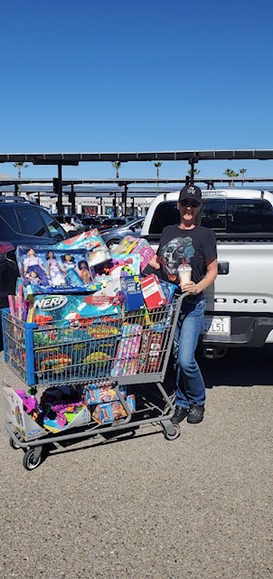  A person standing next to a shopping cart at a support event