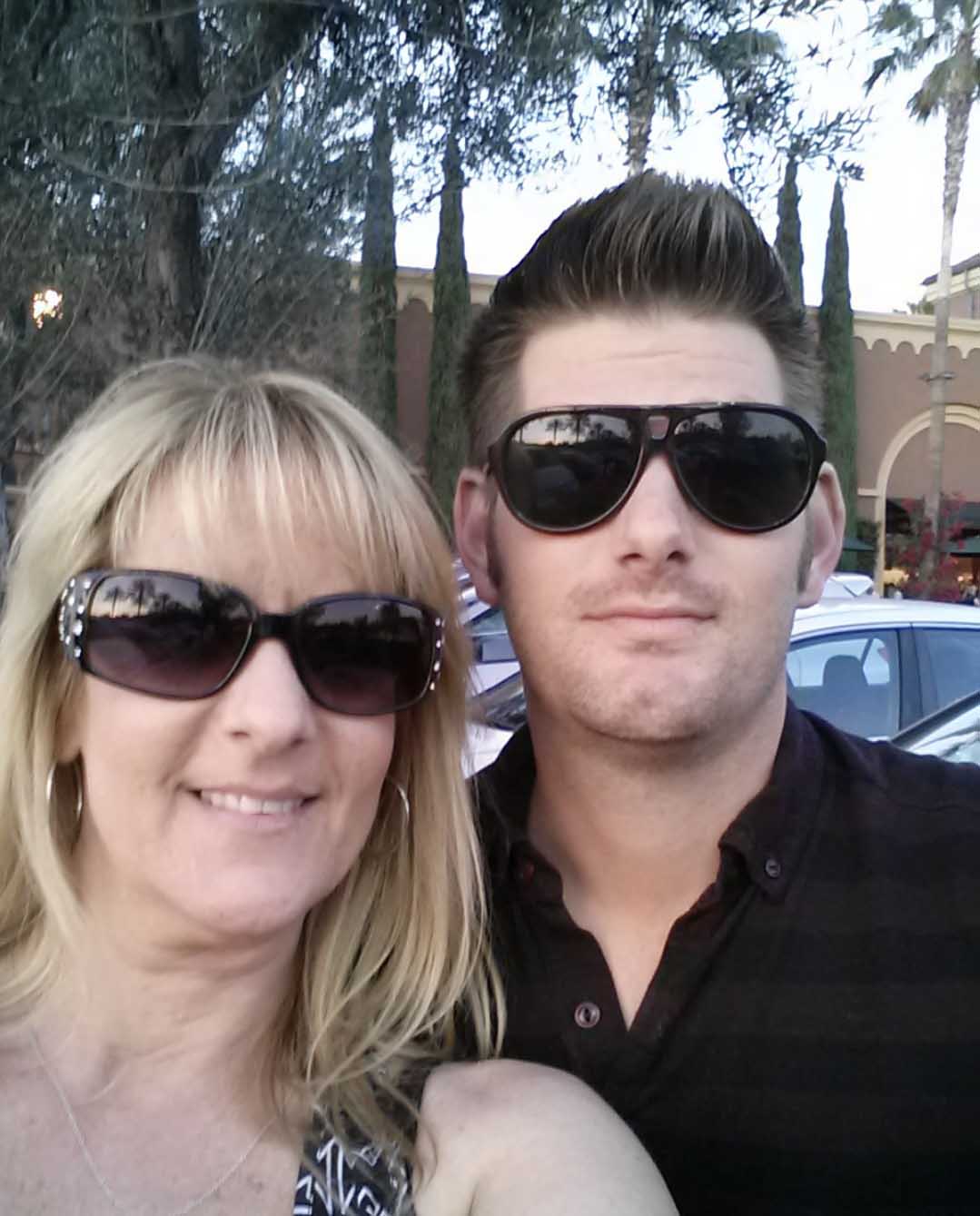 Two people wearing sunglasses at a community event