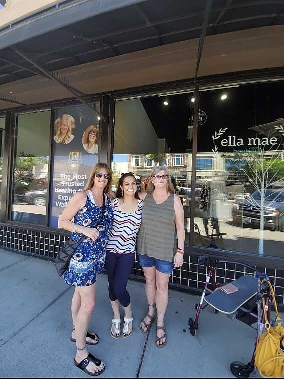 A group of women gathered outside a store during a Just Believe Foundation activity