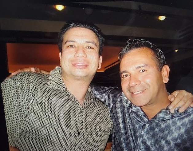 Two men posing for a picture at a nonprofit gathering